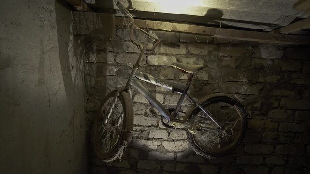 Close-up view of a dusty handlebar on an old bicycle stored indoors. Visible wear, aged materials, and accumulated dust highlight long-term storage, classic construction, and restoration potential.