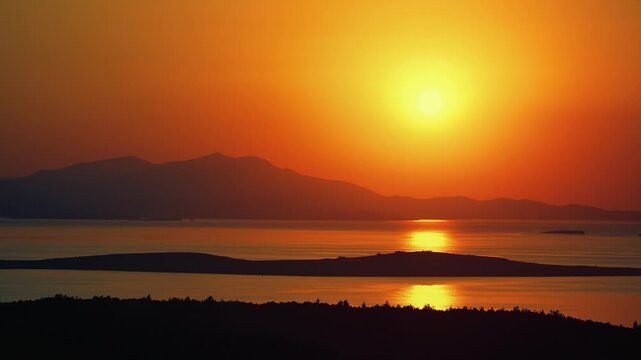 Vibrant golden sunset over the Aegean Sea and islands from Seytan Sofrasi hill viewpoint in Ayvalik, Turkey