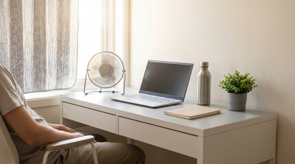 Fototapeta premium Apartment home office cooling setup for remote work during summer heat