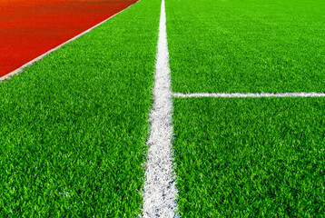 Obraz premium Football green field with white line and running rubber track texture with. Sport background concept.