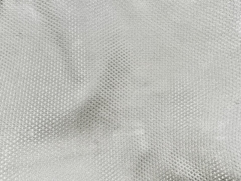 silver gray micro mesh fabric texture creates dynamic metallic waves for modern activewear design backdrops