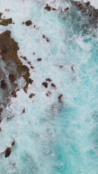 Vertical aerial drone waves on lava coastline Tenerife &mdash; portrait format