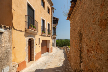 Obraz premium Miravet village street with traditional architecture and stone walls