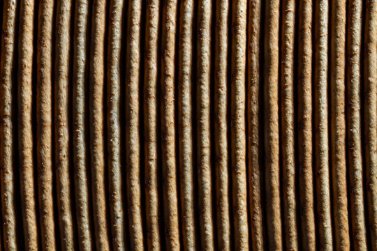 Rye crispbread stack macro texture abstract food background. Closeup full frame view of crunchy rye crispbreads or crackers or sweet straw stacked together creating a linear textured background
