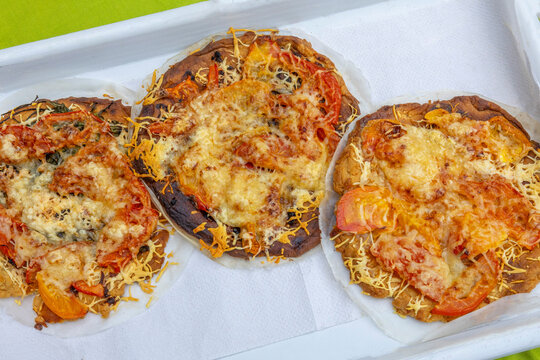 Three Pizzas With Cheese and Vegetables on a Tray