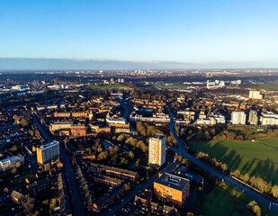 Fototapeta premium Sunny Aerial View of Urban Neighborhood and Green Parkland at City Edge