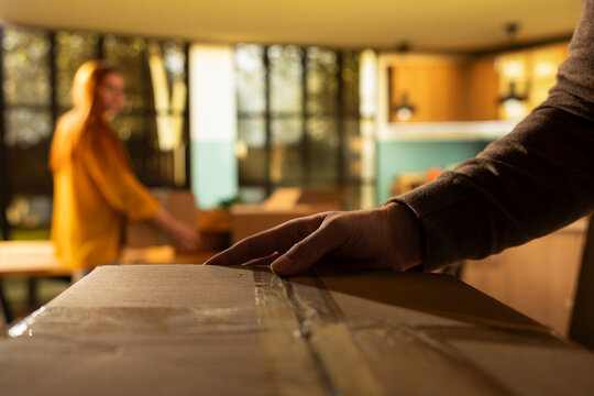POV of young man carrying cardboard boxes into their forever home, moving day concept showing relocation and unpacking furniture to settle in, Happiness of a fresh start and new life event.