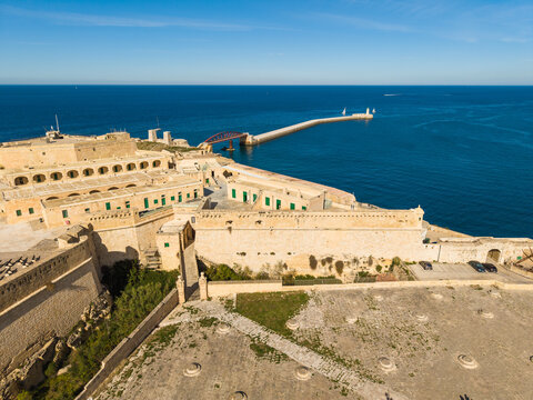 Aerial view of Abercrombie's Bastion and the historic stone fortifications of Fort St. Elmo overlooking the Mediterranean Sea and breakwater in Valletta, Port Region, Malta.