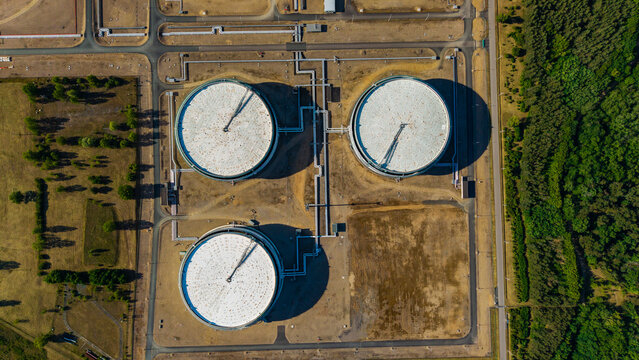 Aerial view of three large circular storage tanks at the Unipetrol RPA refinery with connecting pipelines and surrounding industrial infrastructure Kralupy nad Vltavou, Stredocesky kraj, Czechia.