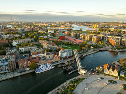 Aerial view of the Motlawa River with the raised Olowianka Footbridge, the Museum of the Second World War, and historic buildings in Gdansk, Pomeranian Voivodeship, Poland.