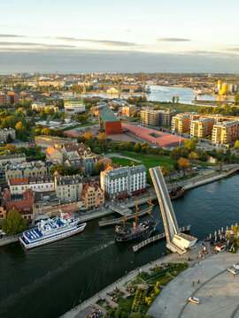 Aerial view of the raised drawbridge over the Motlawa river with a galleon ship and the Museum of the Second World War in Gdansk, Pomeranian Voivodeship, Poland.