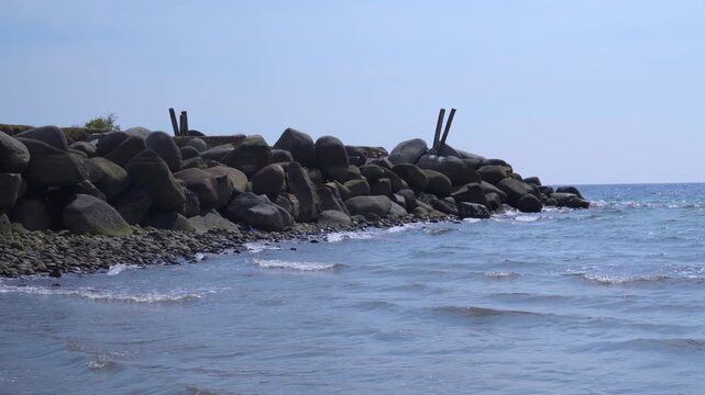 Gentle Ocean Waves Breaking Near Rocky Tropical Shore &ndash; 4K Stock Video