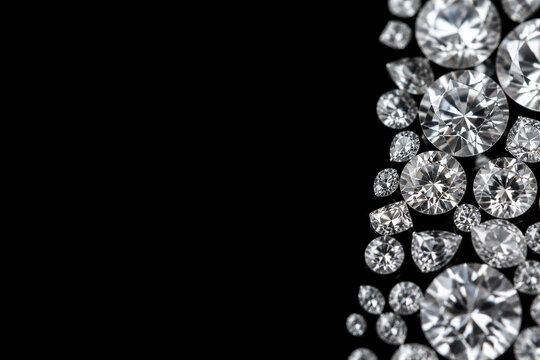 Round cut diamonds clustered along black background edge