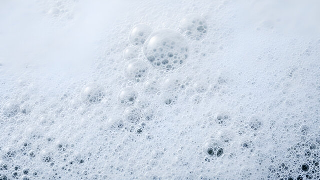 Close-up view of white foam with numerous small bubbles and clear transparent orbs on surface