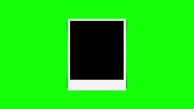 A clean animation of a single blank instant film frame with a black placeholder dropping onto a bright chroma key green screen background.