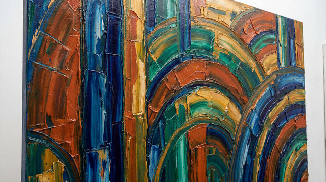 Vibrant abstract oil painting with thick impasto texture and colorful brushstrokes. This contemporary art piece features a dynamic pattern of blues, greens, oranges, and yellows.