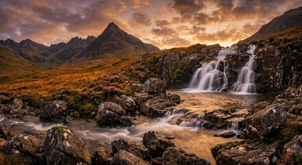 Fototapeta premium Majestic mountain waterfall cascading over rugged rocks under a dramatic golden hour sunset sky