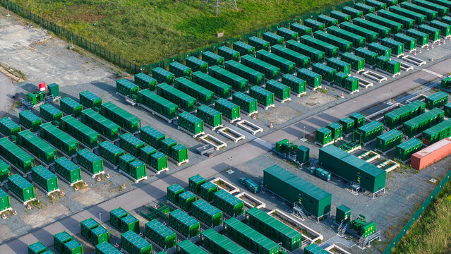 Aerial view of the Thurrock Battery Energy Storage BESS and Flexible Generation Plant with rows of green battery containers on an industrial site in Thurrock, England, United Kingdom.