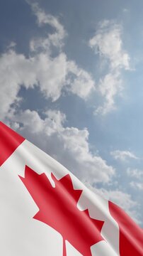 Passenger Airplane Flying Over Canadian Flag Waving Against Blue Sky and Clouds Background