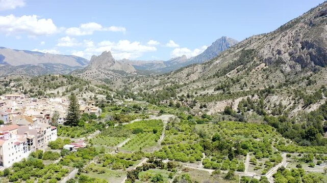 Aerial view of the imposing Puig Campana rising above the peaceful village of Orxeta in Alicante, surrounded by Mediterranean mountains, and rugged inland landscapes, sPAIN.