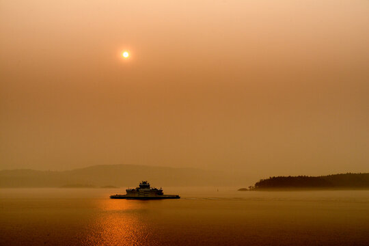 Canada, BC, Gulf Islands,  The sun and the view obscured by forest fire smoke