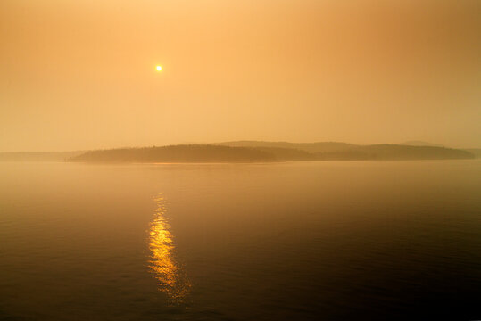 Canada, BC, Gulf Islands,  The sun and the view obscured by forest fire smoke