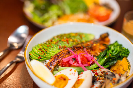 Closeup of nutritious lunch bowl with avocado fish and egg