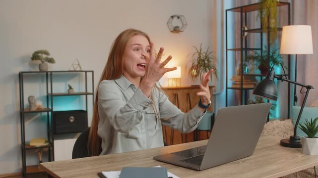 Stressed mature businesswoman looking at unpaid bank debt bills, doing paperwork, planning budget calculate finances mortgage payments. Freelancer girl throws paper bills sitting at home office table.