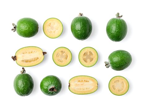 View of whole and halved feijoa fruits arranged symmetrically