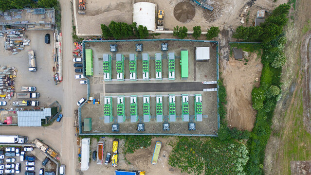 Aerial view of Damhead Creek Power Station Battery Energy Storage Systems BESS with green units arranged in rows within a fenced industrial site Rochester, England, United Kingdom.