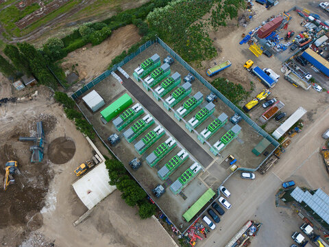 Aerial view of Damhead Creek Power Station Battery Energy Storage Systems BESS featuring rows of green battery containers within a fenced compound Rochester, England, United Kingdom.