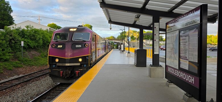 Purple Commuter Train Arriving at Middleborough Station, Symbolizing Public Transit and Urban Daily Travel