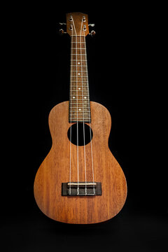  Wooden soprano professional ukulele on black background