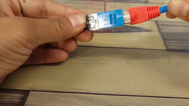 Plugging RJ45 Ethernet cable to network port, wired internet connection, networking equipment, and data communication technology.