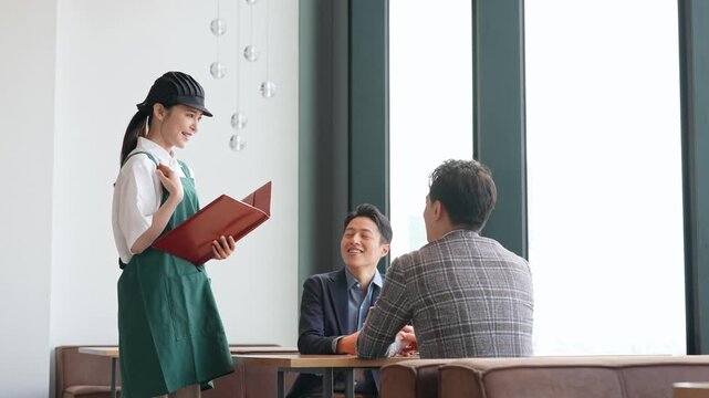 店内で接客する飲食店店員