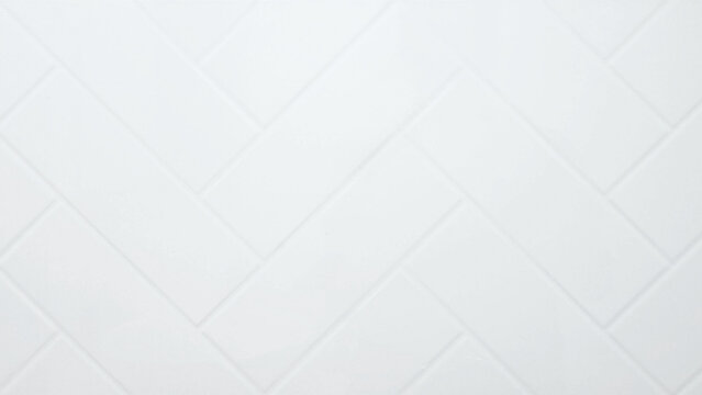Clean white herringbone tile texture background. Minimalist diagonal subway tile pattern for modern kitchen backsplash or bathroom wall.