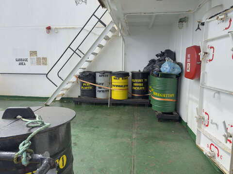 garbage collection on board the ship. seafarers use painted in different colors as per category barrels after the oil supply to store garbage on board