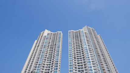 High-Rise Apartment with Clear Blue Sky Background, View from a Low Angle © Achmad Agus Ilyas