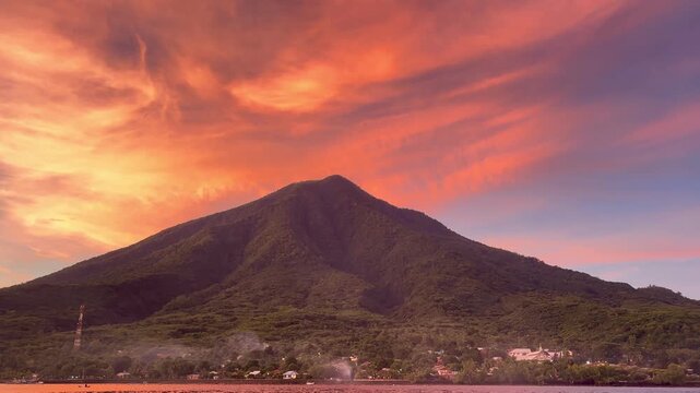 Cinematic b roll of majestic Mount Ile Mandiri during dramatic orange sunset sky in Flores Indonesia