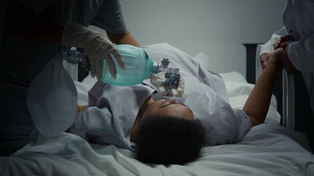 Black woman receiving emergency oxygen from medical professional using manual resuscitator bag in hospital. Ideal for healthcare training and medical emergency commercial campaigns,