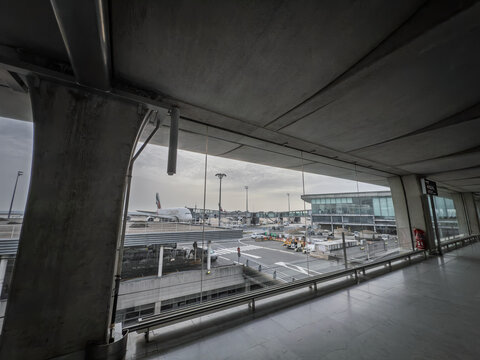 PARIS, FRANCE - MARCH 6, 2026: Emirates Airbus A380 aircraft seen from an airport terminal area in paris france positioned on the apron before departure to Dubai with gates,and airport infrastructure.