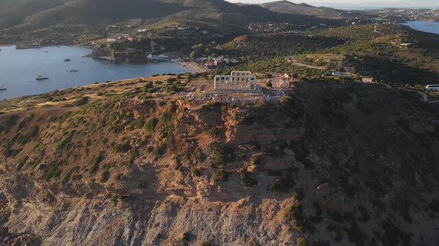Aerial view of the ancient Temple of Poseidon at Cape Sounion on a rocky cliff overlooking the Aegean Sea in East Attica Regional Unit, Greece.