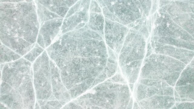Drone view of half frozen lake with ice on water, close up view of blue ice crack and bubbles in earl spring day, top view ice floating on lake, 4k real time footage travel concept.