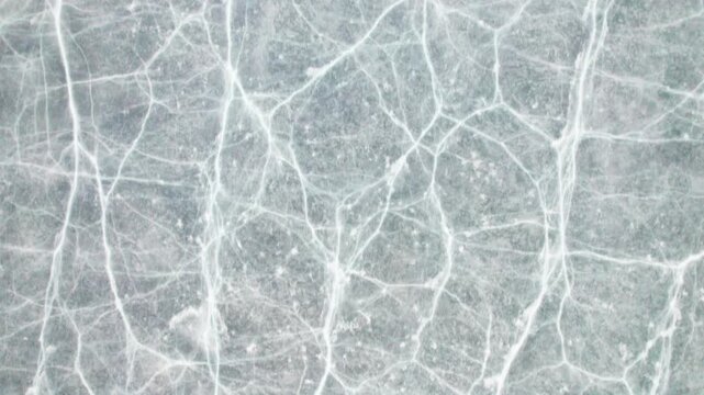 Drone view of half frozen lake with ice on water, close up view of blue ice crack and bubbles in earl spring day, top view ice floating on lake, 4k real time footage travel concept.