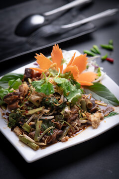 Spicy Thai stewed beef salad with morning glory and bean sprouts.