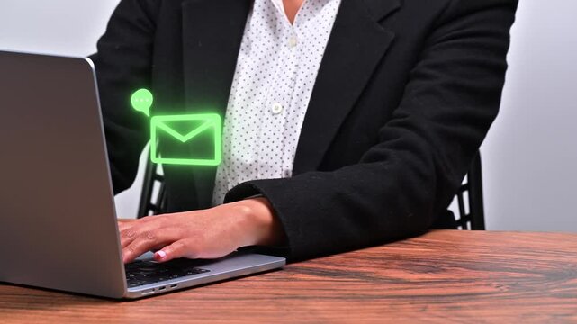 Close-up of female hands using a laptop. Digital communication concept with neon green icons