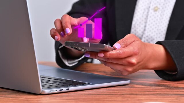 Woman in an office interacting with a high-end smartphone while a holographic icon with a growing graphic appears on the screen