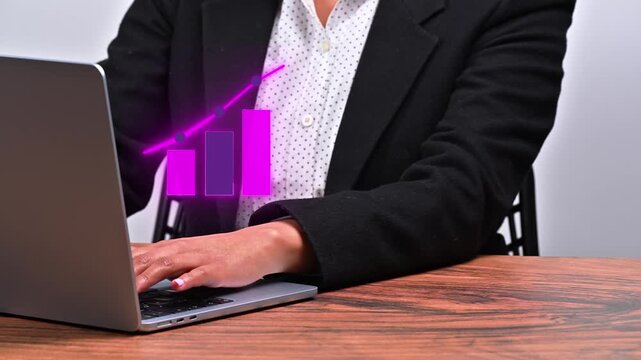 Woman's hands on laptop keyboard with a purple sales data visualization chart