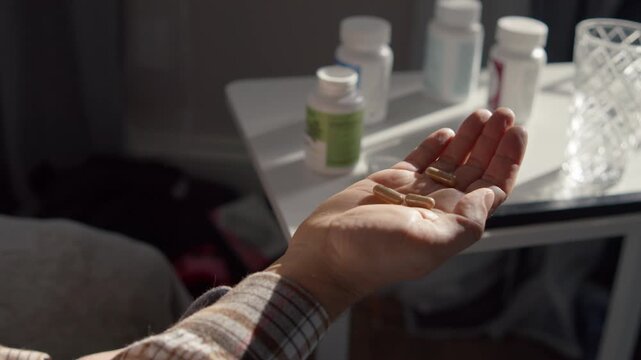 Close Up Male Hands Taking Tablets And Drinking Water At Home Medical Concept Health Recovery Flu Treatment Headache Relief Prevention Lifestyle Scene Perfect For Healthcare Advertising