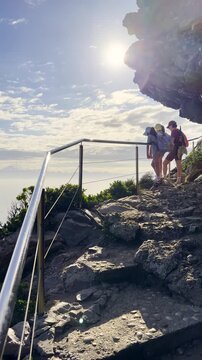 Family at lookout point along Robberg hiking trail in Plettenberg Bay. Vertical